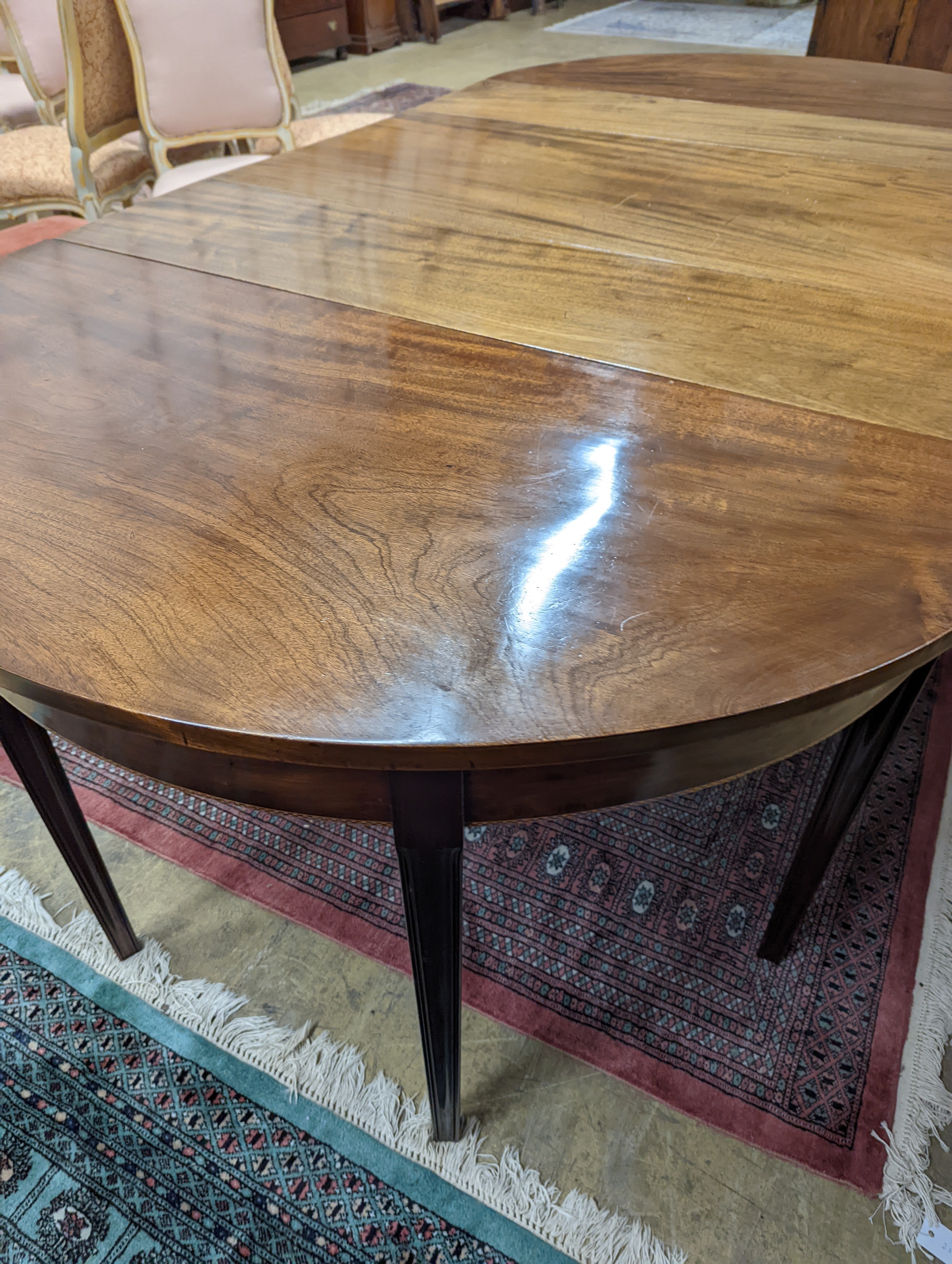 A George III mahogany D end extending dining table, with drop flap central section, length 240cm extended, width 120cm, height 76cm